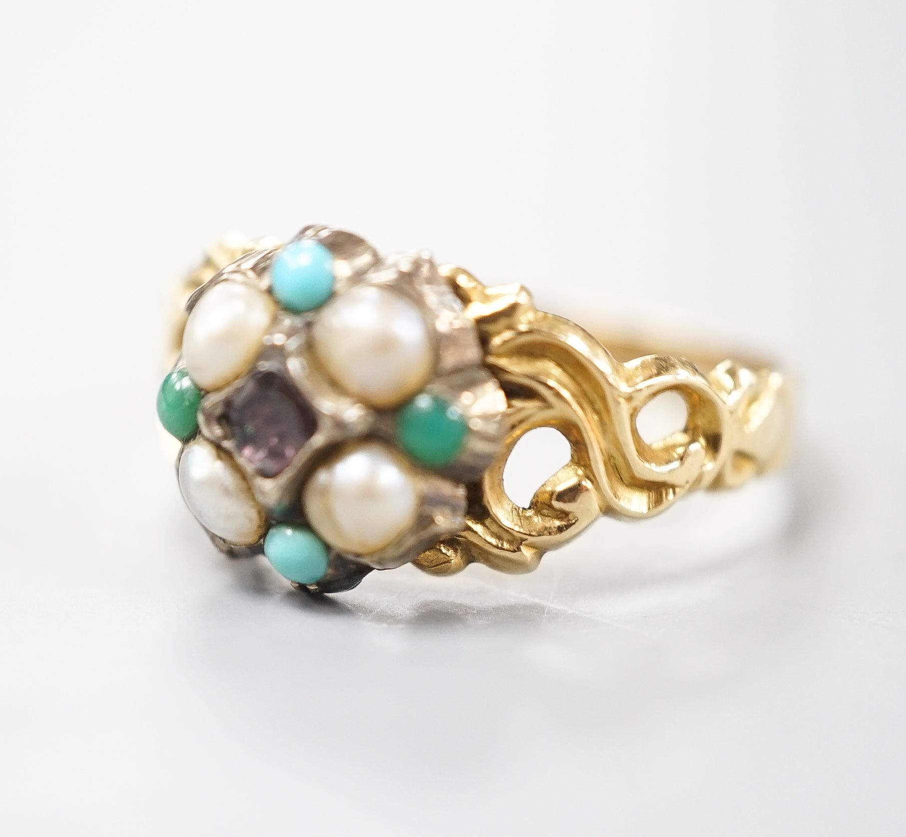 A late Victorian yellow metal, garnet, turquoise and split pearl cluster set dress ring, size M, gross weight 2.9 grams.